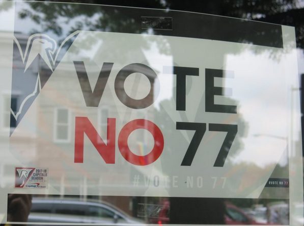 Vote No 77 placard